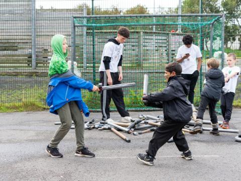 Dueling with foam swords.