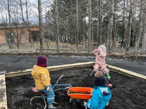 Children playing in a sandbox.