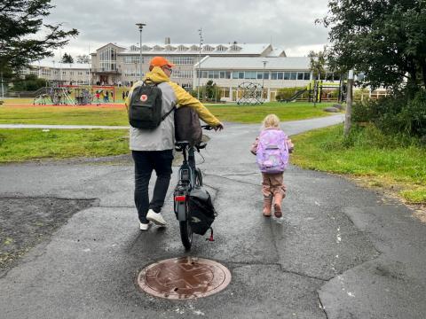 A father and daughter on their way to school.