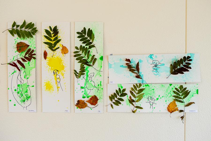 Artwork by children hanging on the wall at Hálsaskógur.