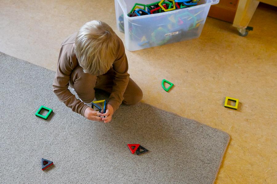 Child playing inside at Hálsaskógur.