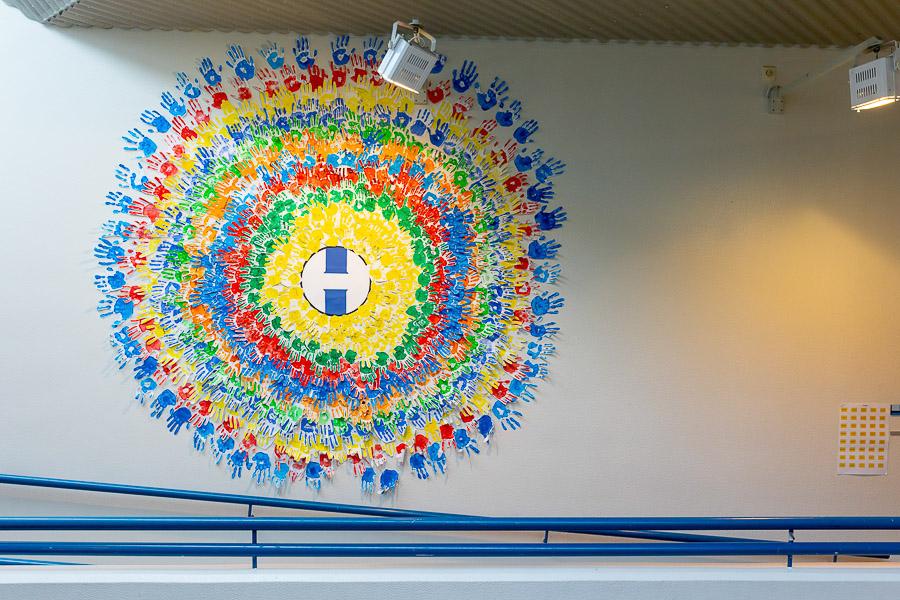 A circle of handprints on a wall.
