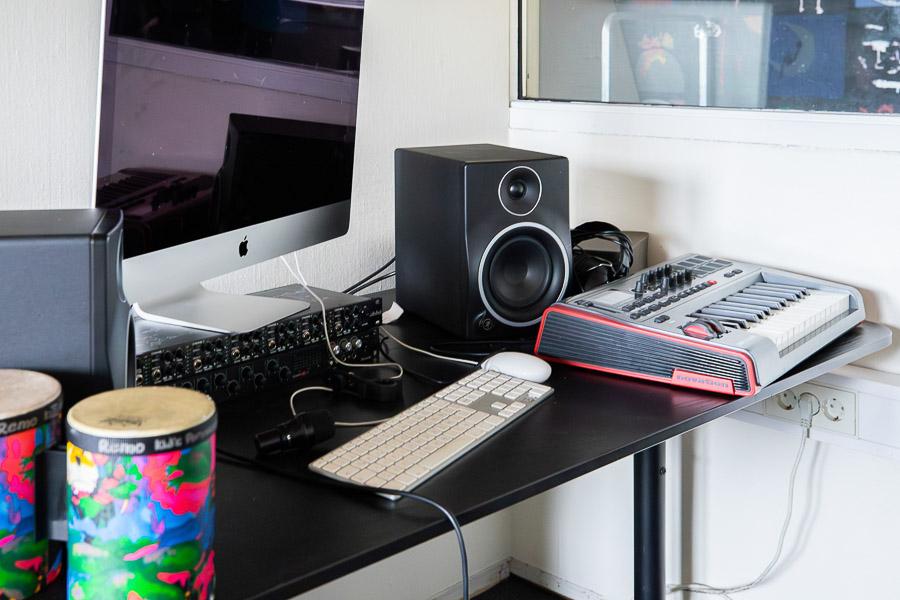 A black table with a computer and various equipment.