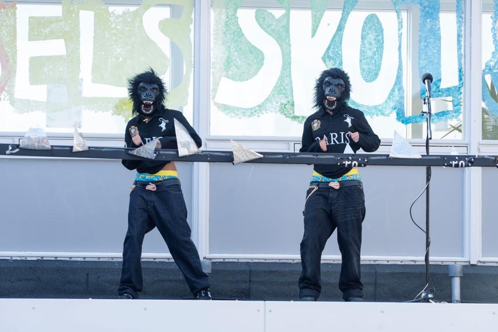 Photo of entertainment acts, two in monkey costumes.