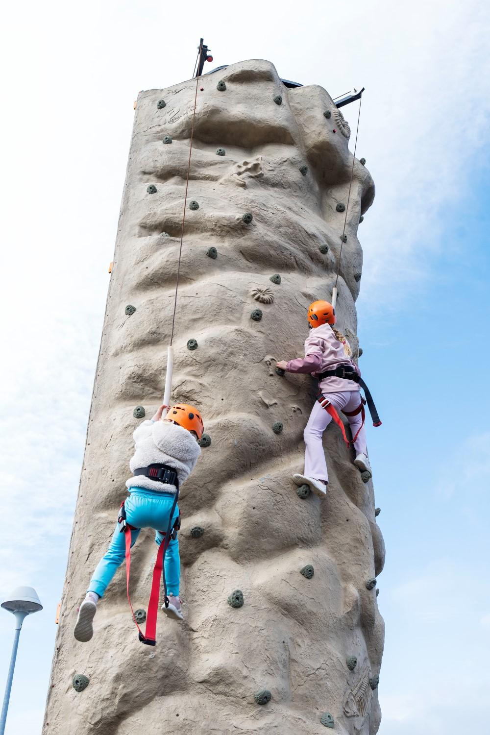Children climbing on climbing wall