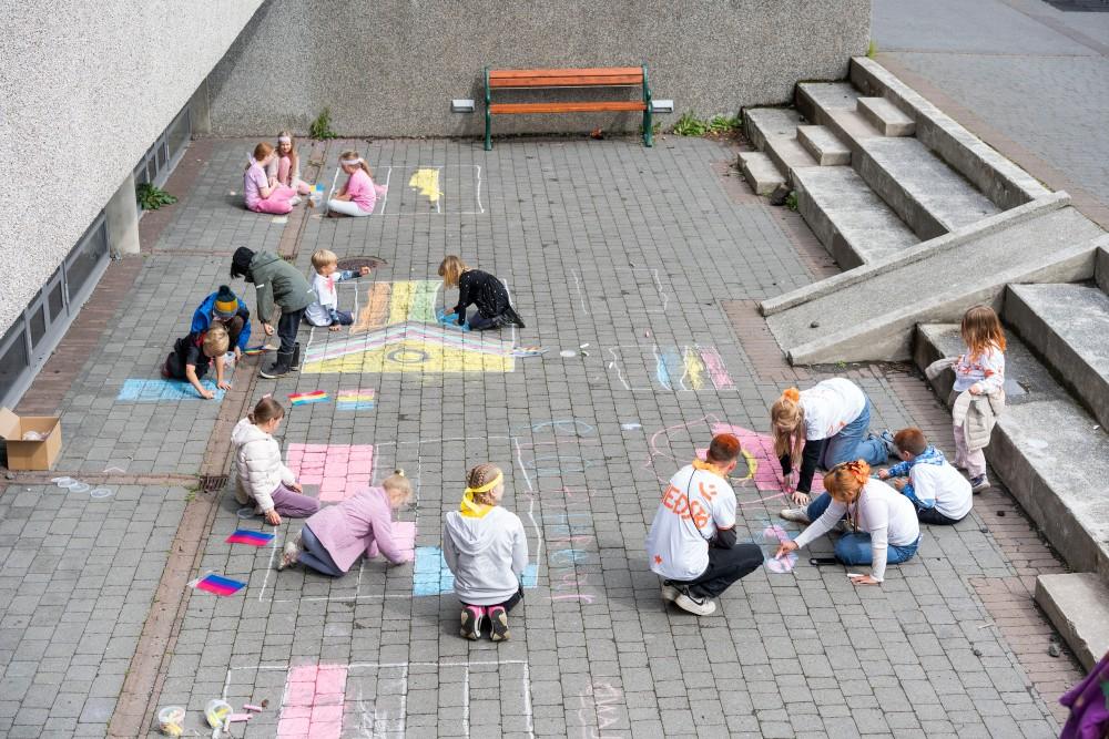 Children chalking on the sidewalk.