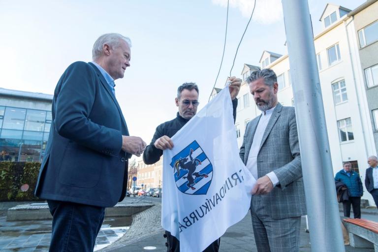 Fannar Jónasson bæjarstjóri Grindavíkur, Þórir Kjartansson öryggis- og húsvörður í Ráðhúsi Reykjavíkur og Dagur B. Eggertsson borgarstjóri Reykjavíkur draga fána Grindavíkur að húni við Ráðhúsið.