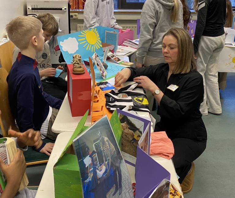 Students and teacher engaged in an art workshop.