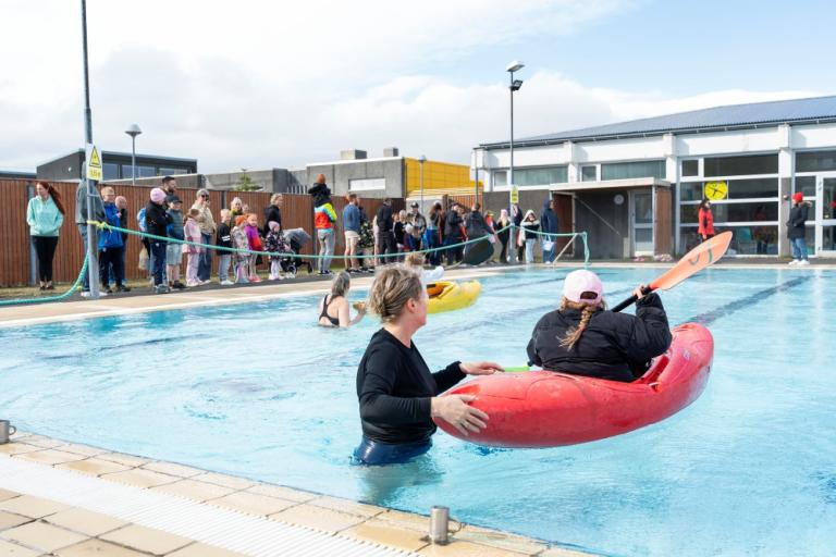 Kayaking in the swimming pool.