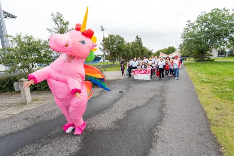 Parade with a pink unicorn in the foreground.