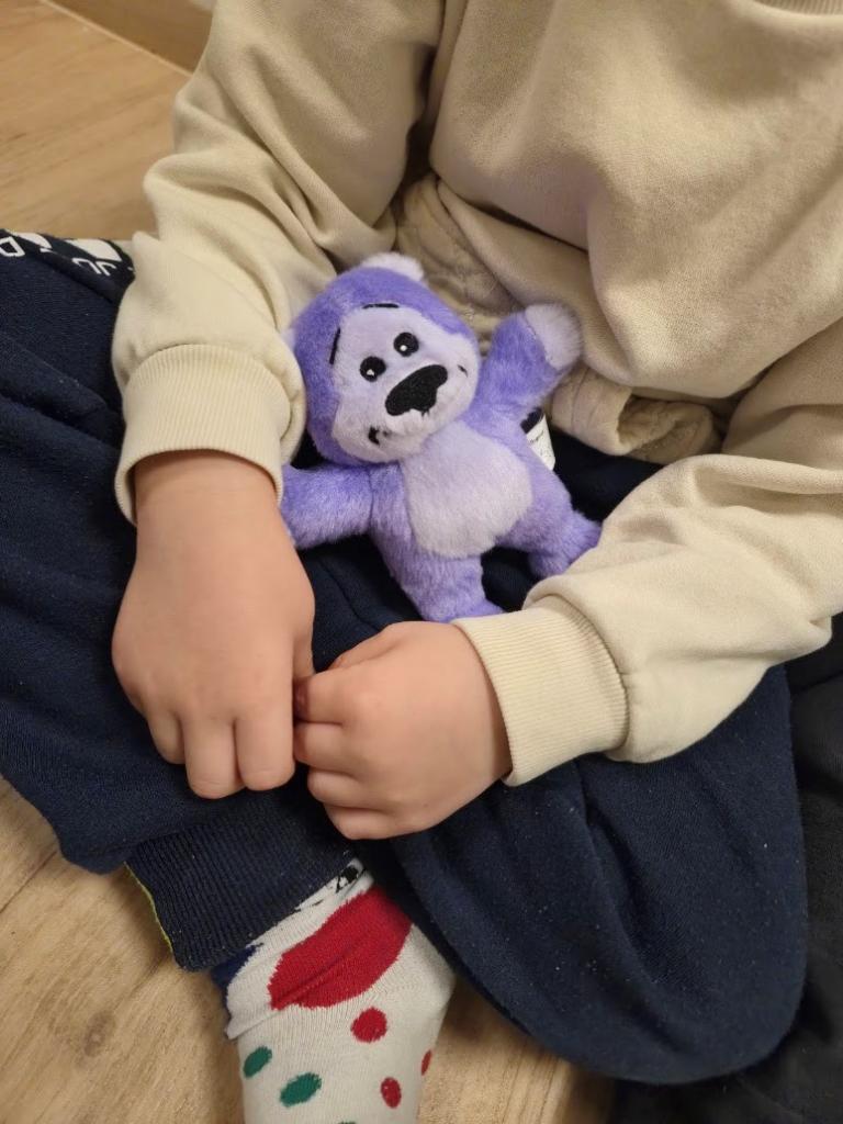 The Blær plush toy being hugged.