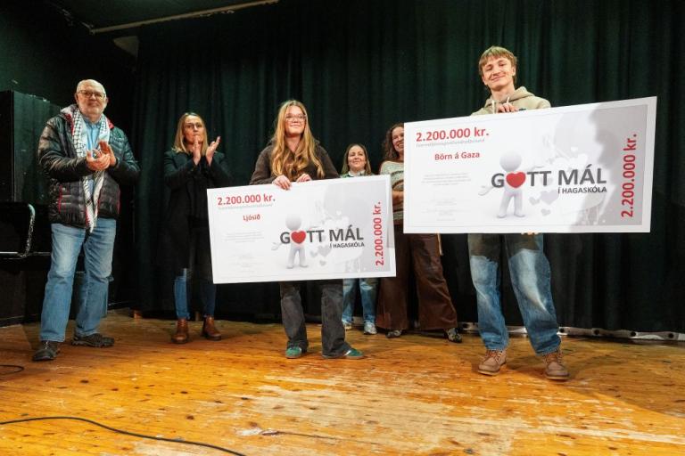 Four people and two ceremonial checks on stage