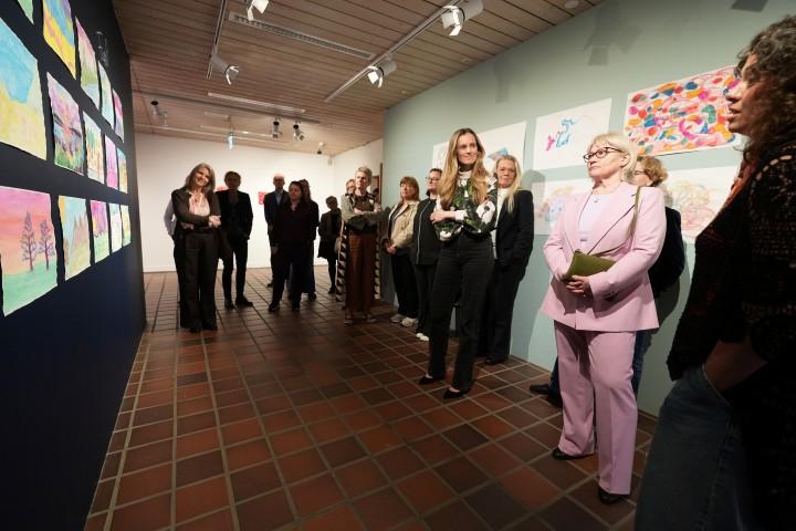 The mayor and other guests view the TINNA Aid group's exhibit at the Reykjavík Arts Festival.