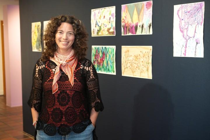  Fríða María Harðardóttir, the exhibit's curator, stands beside several of the works on display.