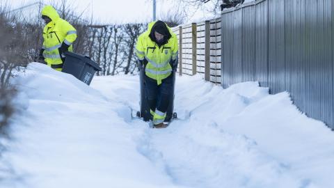 Starfsfólk sorphirðu að störfum í miklum snjó.