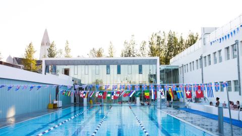 Sundhöll Reykjavík Pool, outdoor area, looking across the deep pool toward the building.