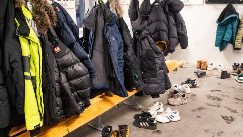 School coat rack full of teenage jackets. 