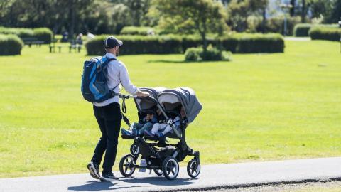A person walking with a stroller.